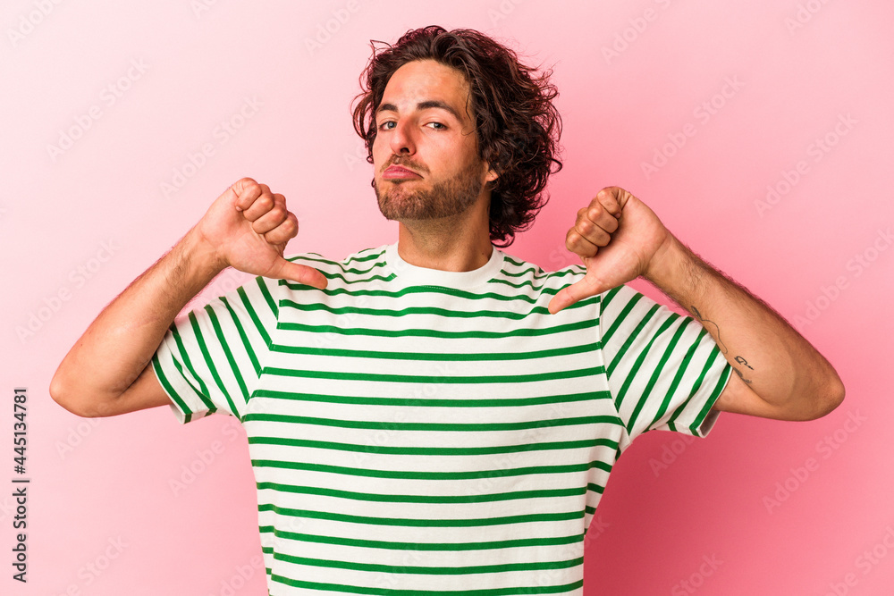 Young caucasian man isolated on pink bakcground feels proud and self confident, example to follow. Young caucasian man isolated on pink bakcground feels proud and self confident, example to follow.