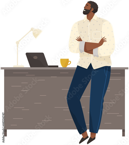 Office worker standing next to table with laptop. Businessman or clerk working at his office workplace. Smiling man enterpreneur resting during break in working day, thinking about something