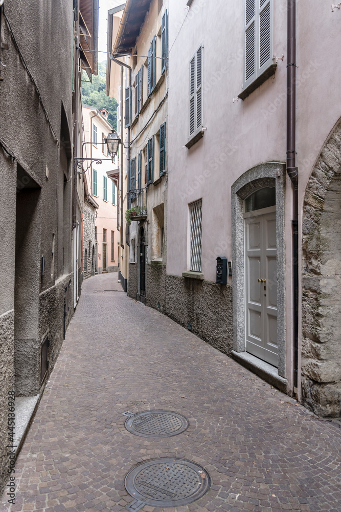 narrow bending street at village on lake shore, Torno,  Como, Italy
