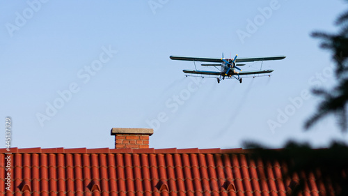 airplane above the rooftops