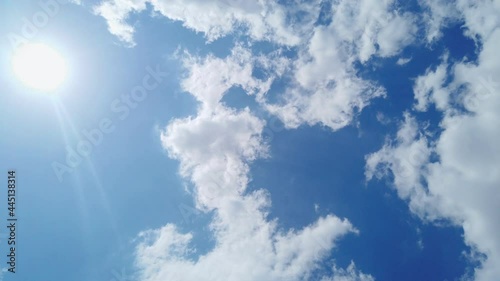 Nadir view with a circular movement of cloud accumulations and the sun with a beautiful blue sky in the background on a sunny day