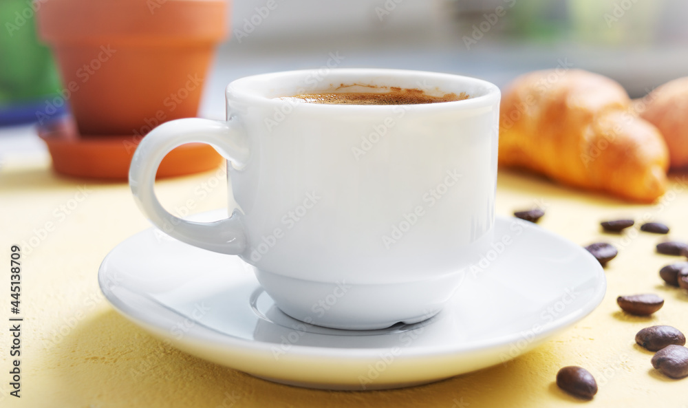 Cup of coffee, fresh croissants on the table. Traditional breakfast. Good morning. Cup of coffee, fresh croissants on the table. Traditional breakfast. Good morning.