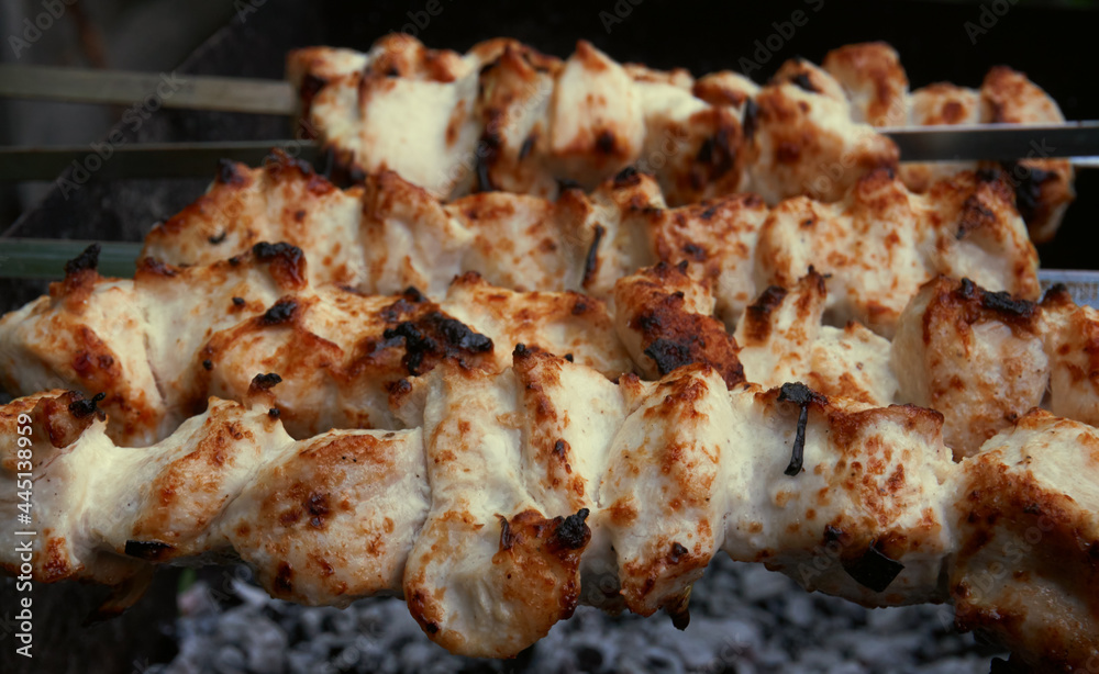 Cooking meat on the grill, barbecue, pieces of meat planted on a skewer. Roasting kebab on coals Cooking meat on the grill, barbecue, pieces of meat planted on a skewer. Roasting kebab on coals