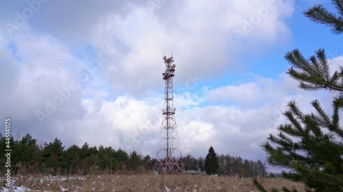 Antenna for TV and radio broadcasting, in a forest winter landscape. The controversy of the development of 5 g frequency for smartphones.