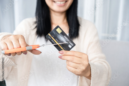 Canvas Print Asian woman hand holding scissors cutting credit card financial, debt freedom co