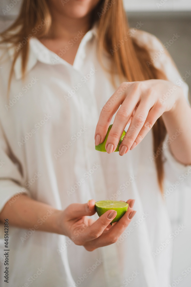 Funny young woman showing slices of lime Funny young woman showing slices of lime
