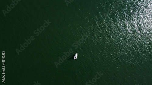 Aerial drone view of sailing boat on a river.
