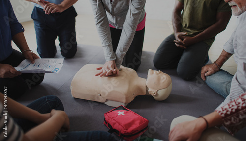 Diverse people taking a CPR first aid training class photo