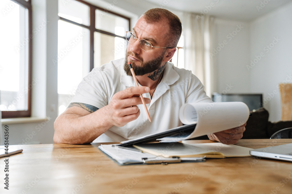 Calm mid aged white man working studying