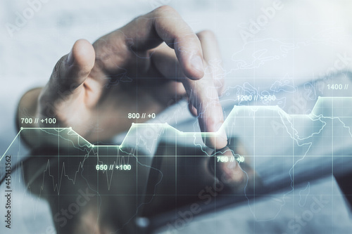 Double exposure of abstract creative statistics data hologram with finger clicks on a digital tablet on background, analytics and forecasting concept