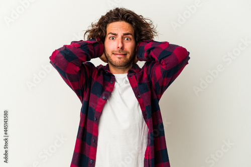 Young caucasian man isolated on white background screaming with rage.
