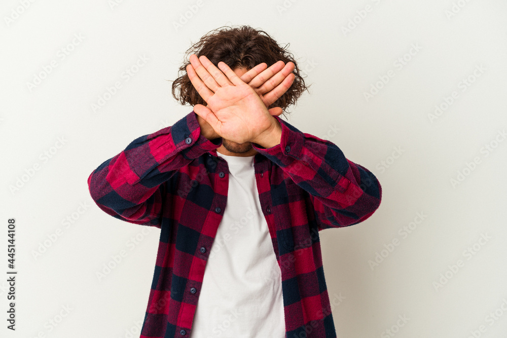 Young caucasian man isolated on white background keeping two arms crossed, denial concept. Young caucasian man isolated on white background keeping two arms crossed, denial concept.