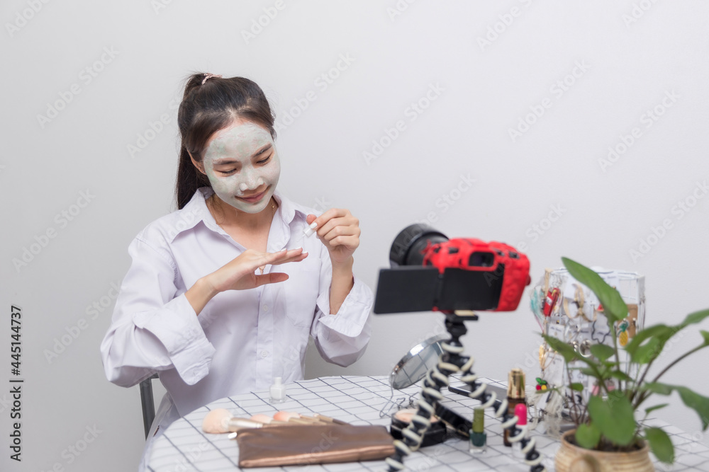 Beautiful woman with facial mask and nail polish at home. Beautiful woman with facial mask and nail polish at home.