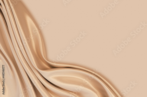 Beautiful elegant wavy light brown / beige satin silk luxury cloth fabric texture with monochrome background design. Copy space