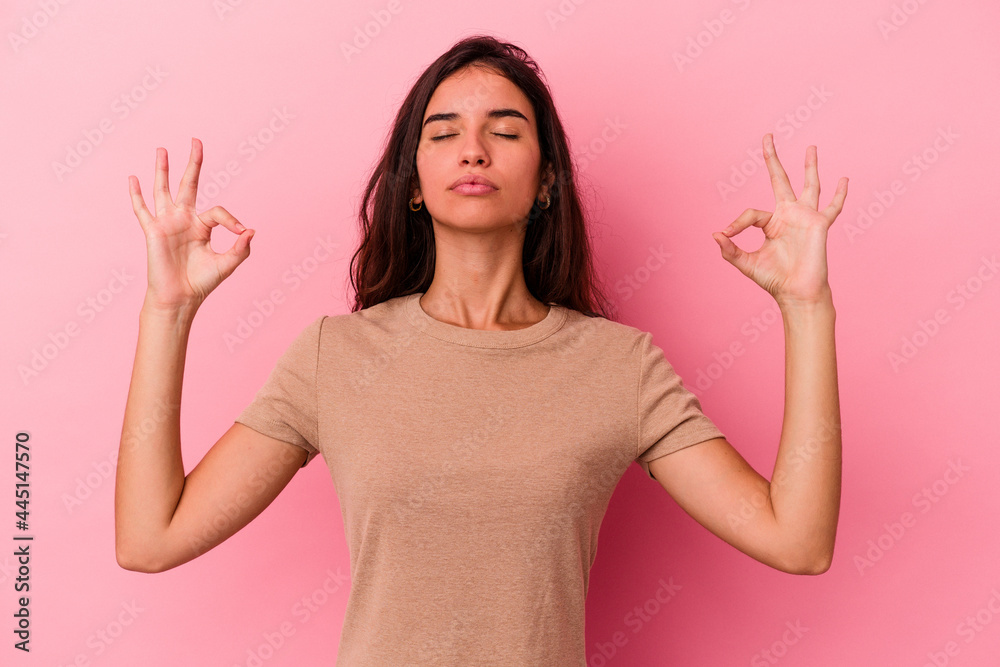 Young caucasian woman isolated on pink background relaxes after hard working day, she is performing yoga. Young caucasian woman isolated on pink background relaxes after hard working day, she is performing yoga.