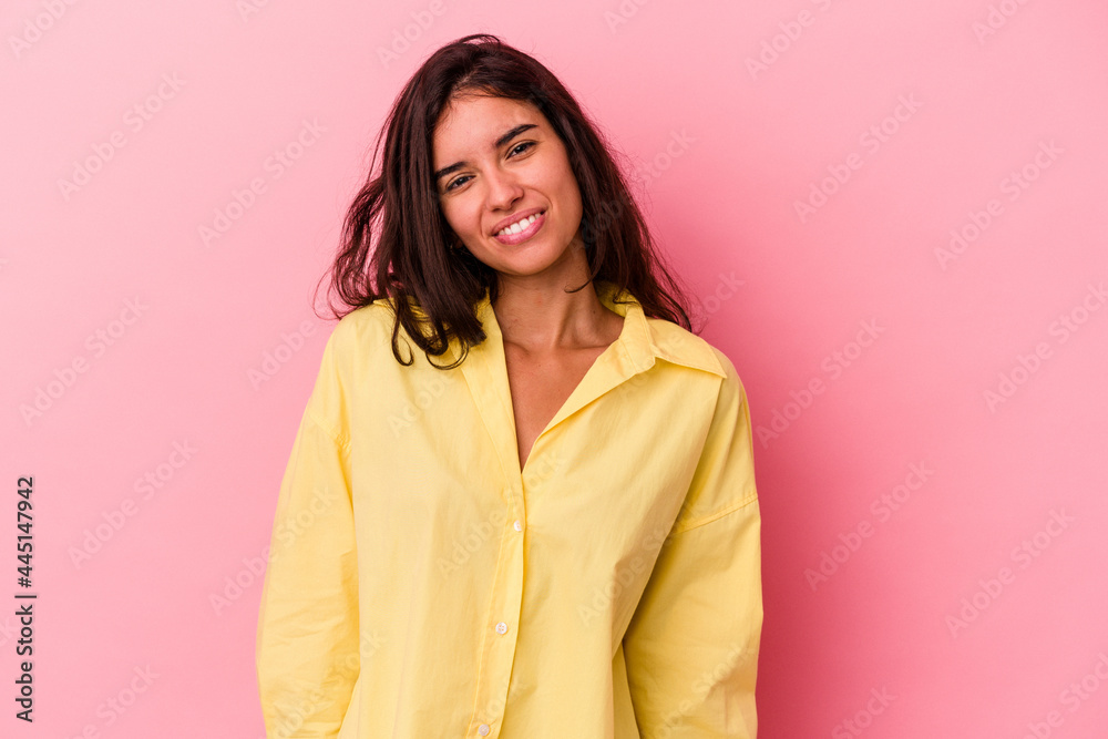 Young caucasian woman isolated on pink background laughs and closes eyes, feels relaxed and happy. Young caucasian woman isolated on pink background laughs and closes eyes, feels relaxed and happy.