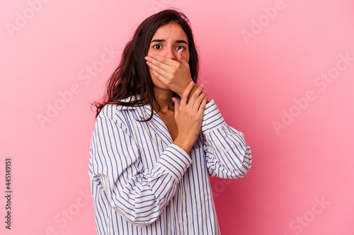 Young caucasian woman isolated on pink background scared and afraid. © Asier
