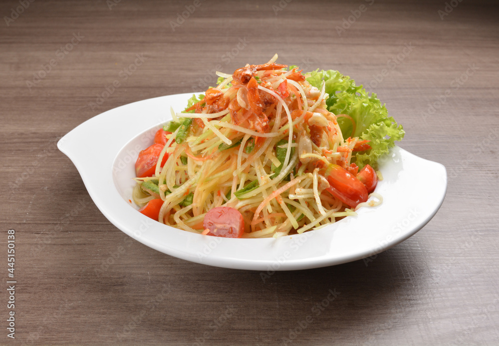 cold thai style spicy chilli sauce papaya and mango vegetable salad and shrimp in bowl on wood table asian Thai appetiser halal menu cold thai style spicy chilli sauce papaya and mango vegetable salad and shrimp in bowl on wood table asian Thai appetiser halal menu