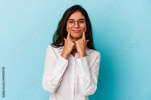 Young caucasian woman isolated on blue background doubting between two options.