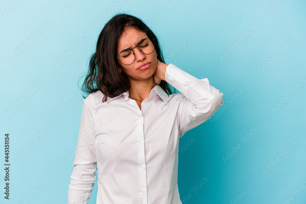 Young caucasian woman isolated on blue background having a neck pain due to stress, massaging and touching it with hand. Young caucasian woman isolated on blue background having a neck pain due to stress, massaging and touching it with hand.