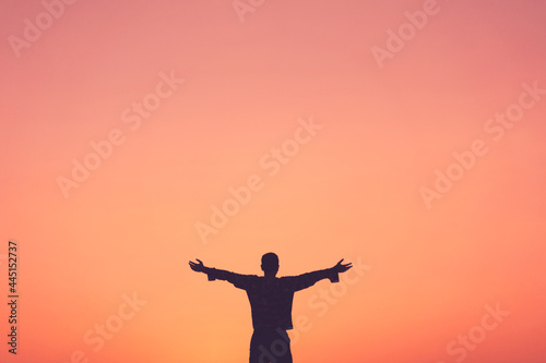 Copy space of man rise hand up on sunset sky at beach and island background.