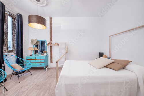 Dormitorio en apartamento vacacional con tocador azul y butacas azules. Decoracion chic para viajeras. photo