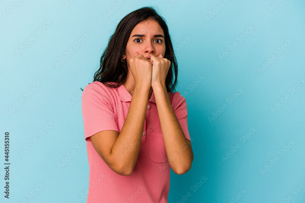 Young caucasian woman isolated on blue background biting fingernails, nervous and very anxious. Young caucasian woman isolated on blue background biting fingernails, nervous and very anxious.