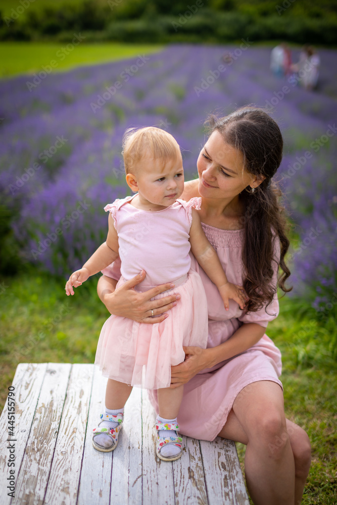 Fototapeta premium Mother with her little daugher on lavender field background in Czech republic