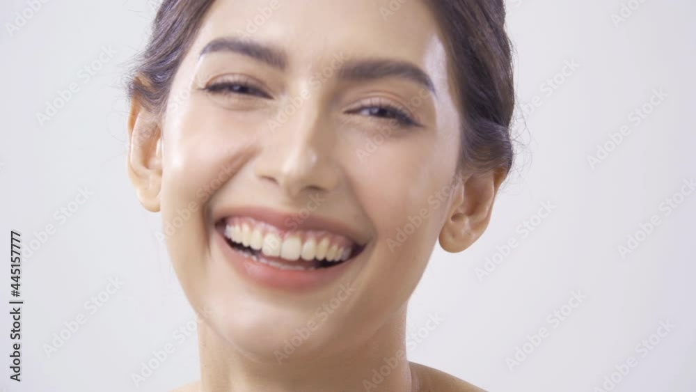 Portrait of beautiful woman laughing at white background. Beautiful woman with perfect makeup. She smiling and looking to camera. Portrait of beautiful woman laughing at white background. Beautiful woman with perfect makeup. She smiling and looking to camera.