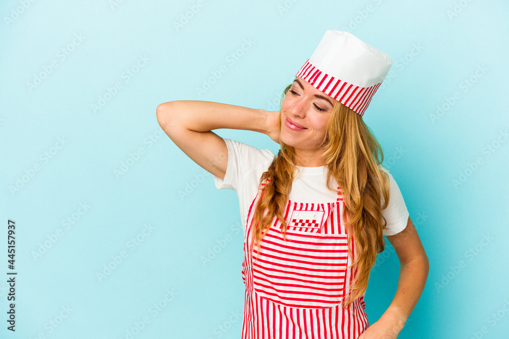 Caucasian ice cream maker woman isolated on blue background touching back of head, thinking and making a choice. Caucasian ice cream maker woman isolated on blue background touching back of head, thinking and making a choice.
