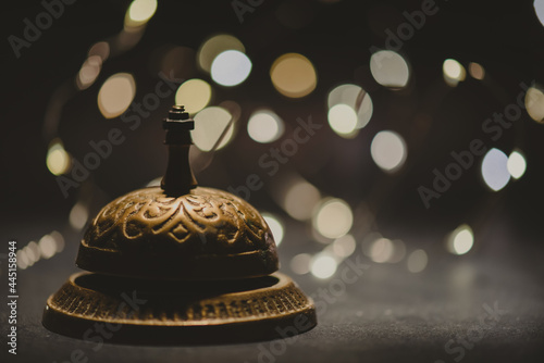 Vintage service bell with bokeh on dark backround