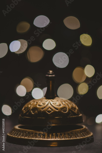 Vintage service bell with bokeh on dark backround