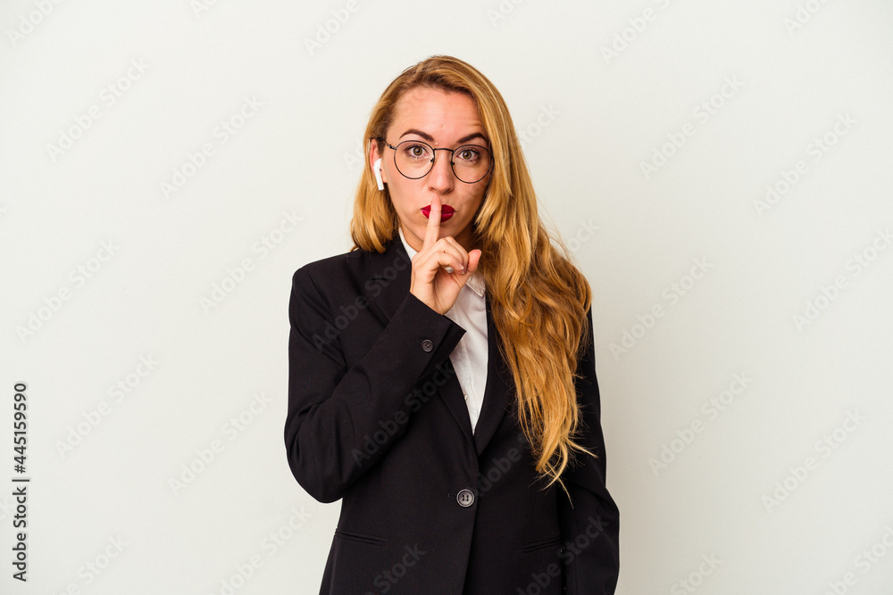 Caucasian business woman wearing a wireless headphones isolated on white background keeping a secret or asking for silence. Caucasian business woman wearing a wireless headphones isolated on white background keeping a secret or asking for silence.