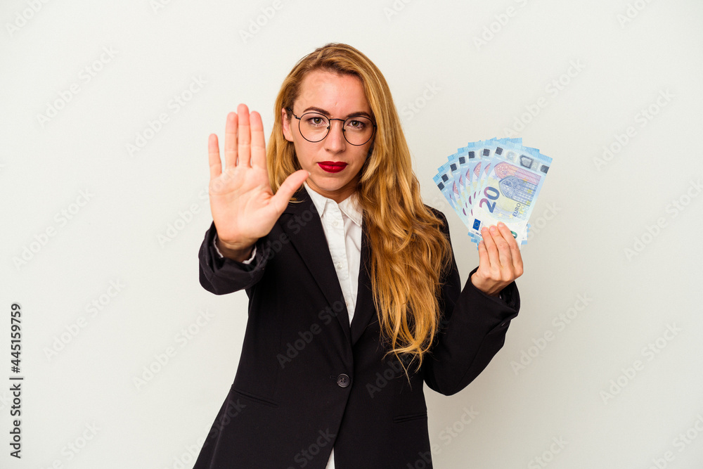 Caucasian business woman holding bills isolated on white background standing with outstretched hand showing stop sign, preventing you. Caucasian business woman holding bills isolated on white background standing with outstretched hand showing stop sign, preventing you.