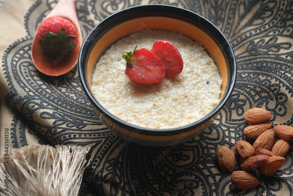 oats flakes and strawberry on wooden table oats flakes and strawberry on wooden table