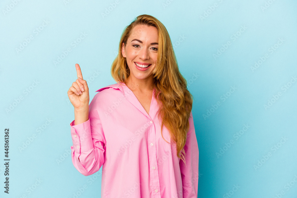 Caucasian woman isolated on blue background showing number one with finger. Caucasian woman isolated on blue background showing number one with finger.