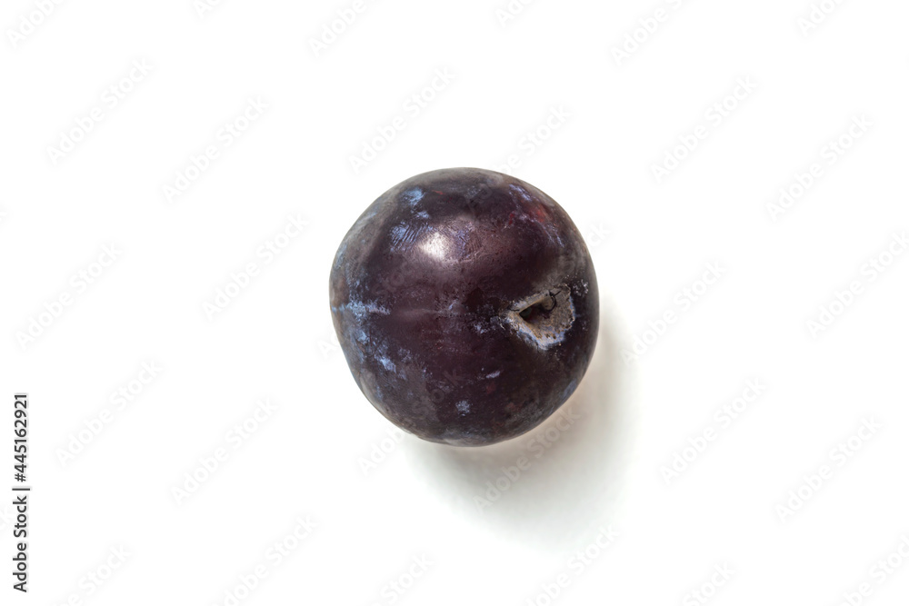 ripe round plum on a white background close-up ripe round plum on a white background close-up