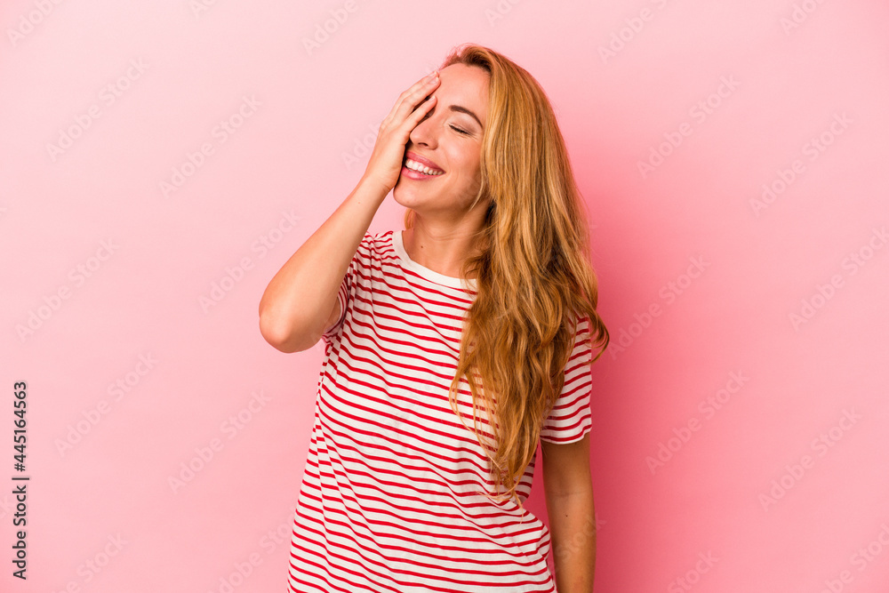 Caucasian blonde woman isolated on pink background laughing happy, carefree, natural emotion. Caucasian blonde woman isolated on pink background laughing happy, carefree, natural emotion.