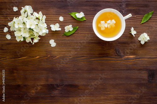 Fototapeta Naklejka Na Ścianę i Meble -  Tea in a cup with jasmine flowers. Herbal tea top view