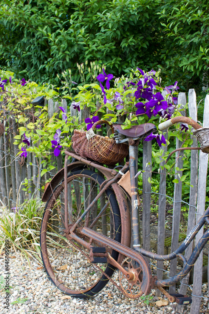 old vintage bicycle with basket on a wooden fence