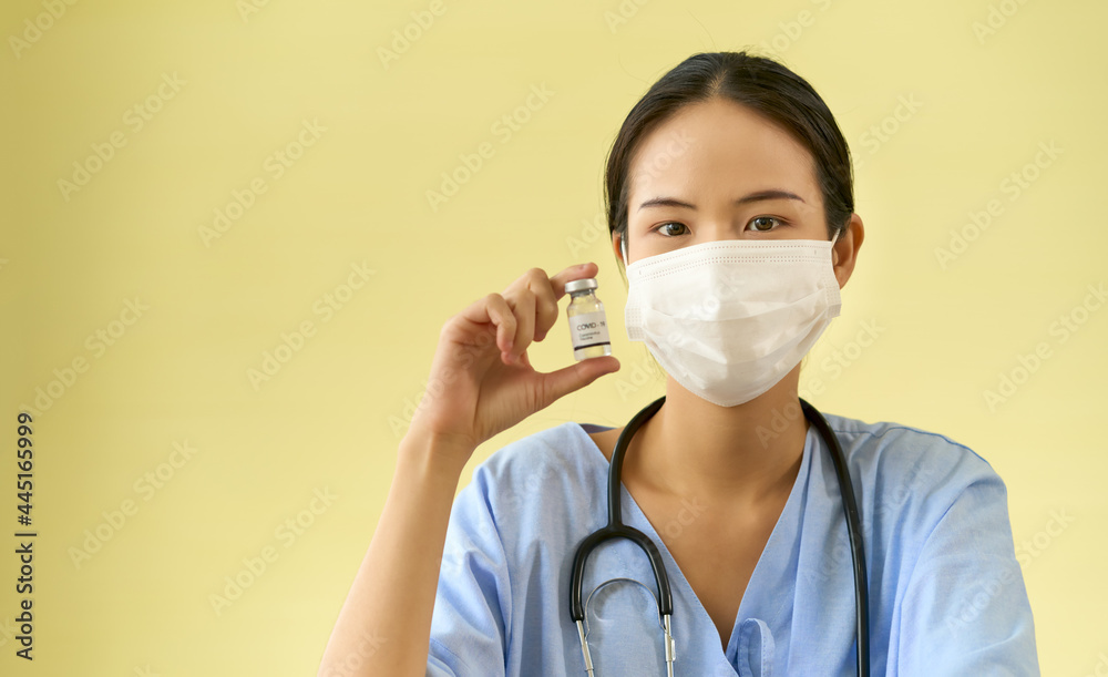 Asian Doctor show vaccine bottle for injection to patient to protect people form covid19 Asian Doctor show vaccine bottle for injection to patient to protect people form covid19