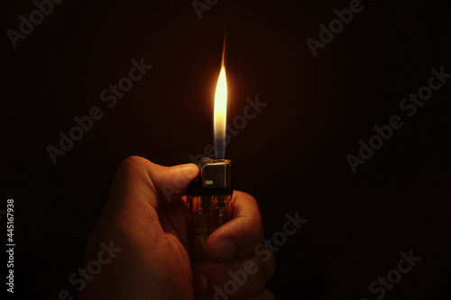 Lighter in the hand on black background