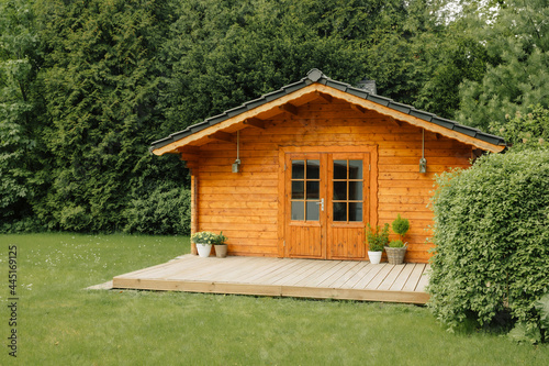  flowers in front of a wooden hut. Garden joy in summer. Relax in the garden and enjoy the beautiful weather. Lavender and hydrangea in pot next to a garden shed 