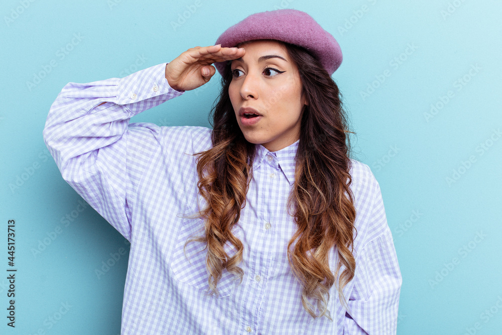 Young mexican woman isolated on blue background looking far away keeping hand on forehead. Young mexican woman isolated on blue background looking far away keeping hand on forehead.