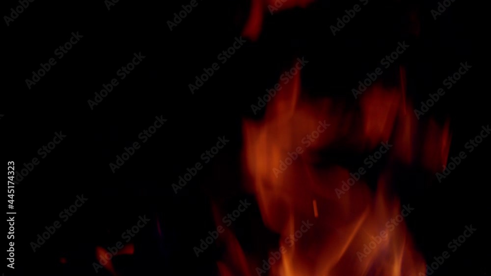 Abstractfire glowing particles on black background. Fire flames burning. Abstractfire glowing particles on black background. Fire flames burning.