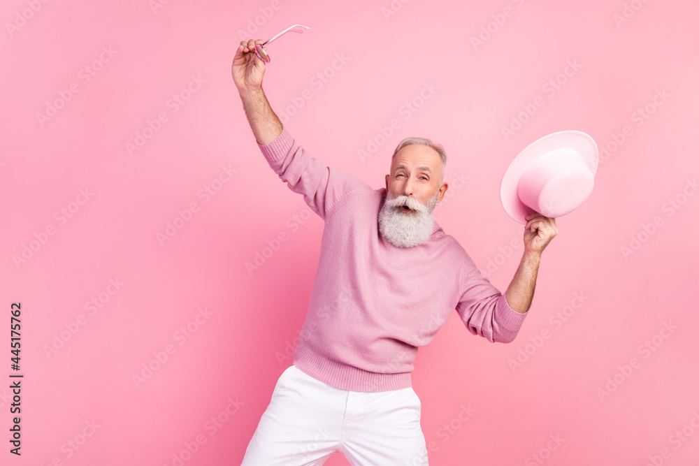 Photo of excited grey hair aged man dance wear eyewear cap sweater isolated on pink background Photo of excited grey hair aged man dance wear eyewear cap sweater isolated on pink background