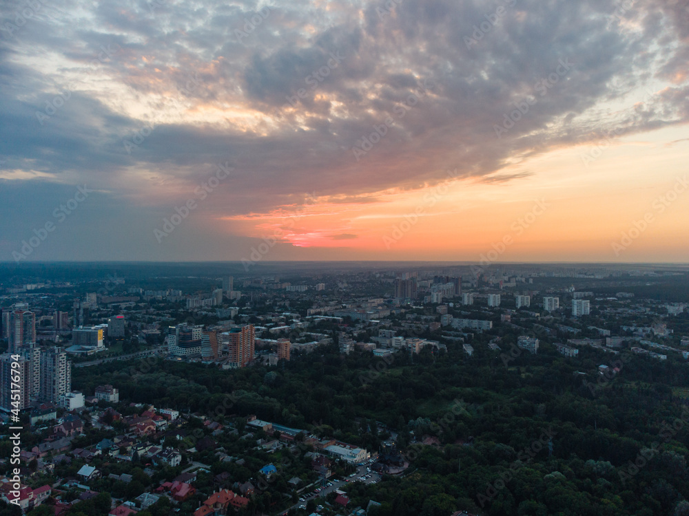 Aerial epic sunset evening cloudscape, panoramic view in summer city recreation park Sarzhyn Yar. Botanical garden in residential Shatilovka district area, Pavlovo Pole, Kharkiv Ukraine