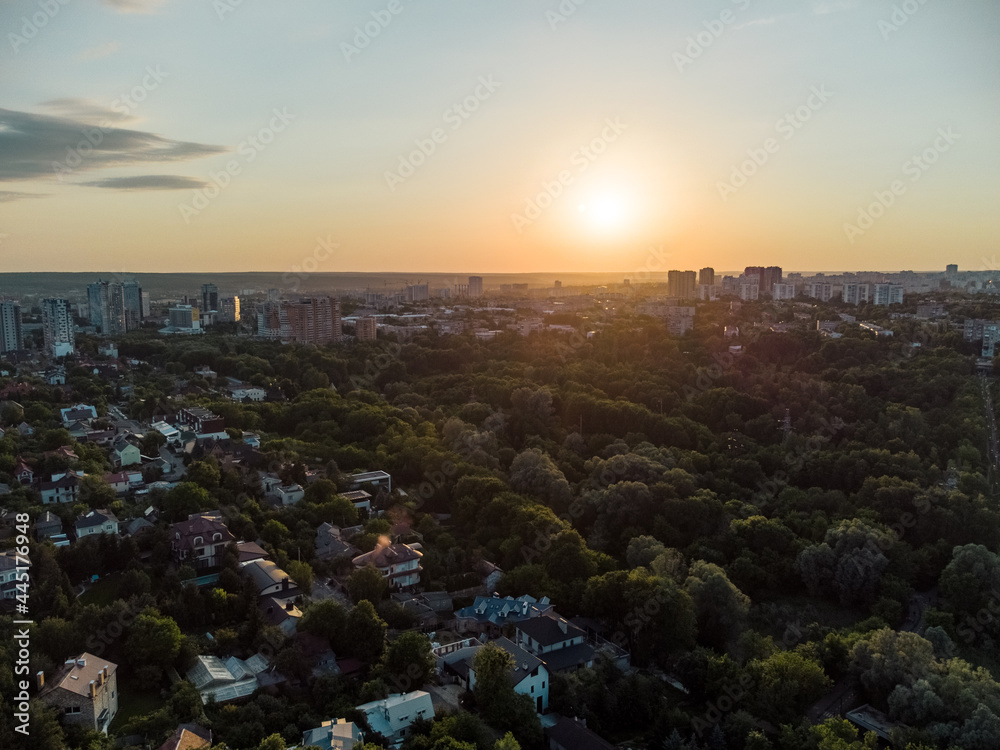 Aerial sunset panorama view on green summer Kharkiv city center popular recreation park Sarzhyn Yar. Botanical garden in residential area in sunlight