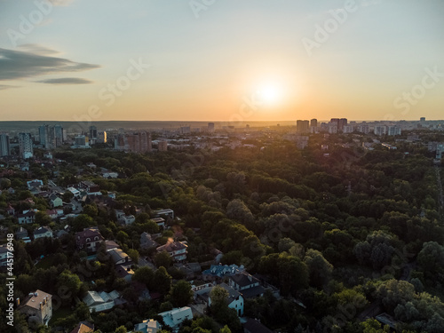 Aerial sunset panorama view on green summer Kharkiv city center popular recreation park Sarzhyn Yar. Botanical garden in residential area in sunlight