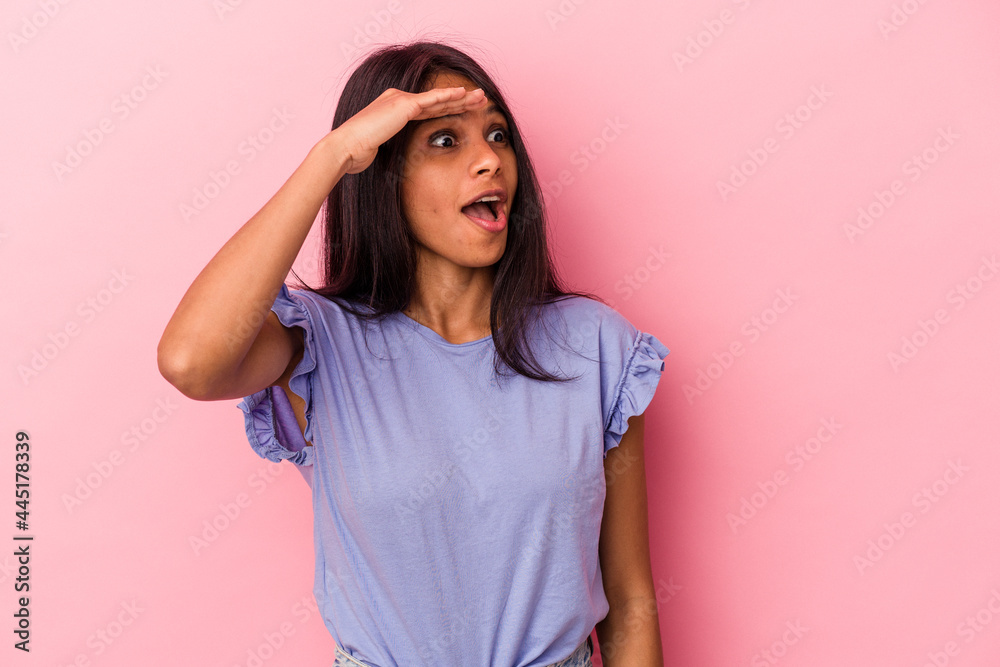 Young latin woman isolated on pink background looking far away keeping hand on forehead. Young latin woman isolated on pink background looking far away keeping hand on forehead.